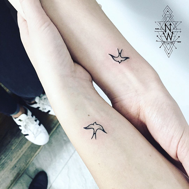 Minimalistic bird trio tattoos on two wrists, showcasing simple and elegant design.