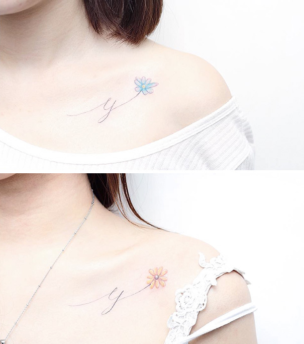 Delicate trio tattoos of flowers on collarbone with cursive script, showcasing simple and elegant design.