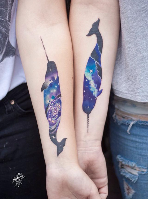 Galaxy-themed narwhal trio tattoos on forearms, blending vibrant colors and cosmic patterns.