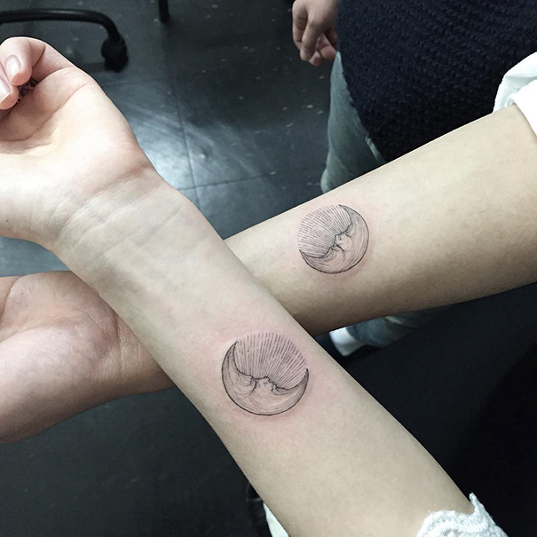 Matching crescent moon tattoos on two forearms, representing trio tattoo ideas.
