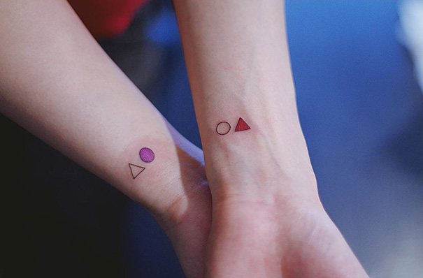 Minimalist trio tattoos with geometric shapes on forearms.