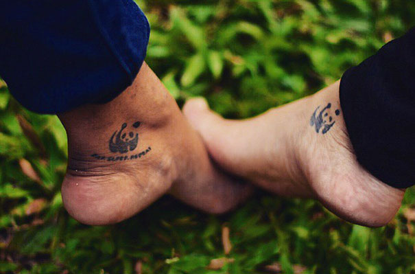 Trio tattoos on two ankles showing matching designs against a grassy background.