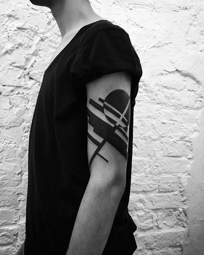 Minimalist tattoo design on arm featuring geometric shapes, created by a Russian artist.