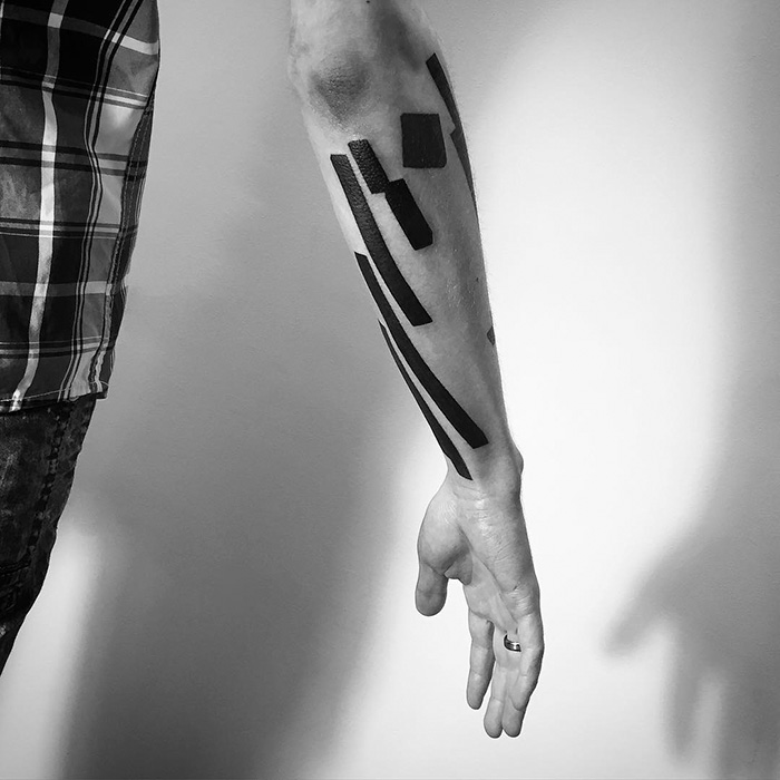 A minimalist digitally-designed tattoo with geometric shapes on an arm, created by a Russian artist.