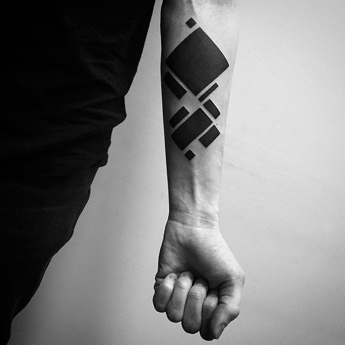Minimalist digitally-designed tattoo on forearm in geometric shapes.