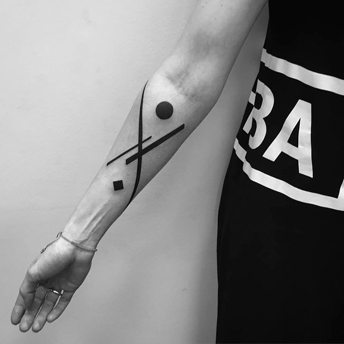 Minimalist digitally-designed tattoo with geometric shapes on a person's forearm.