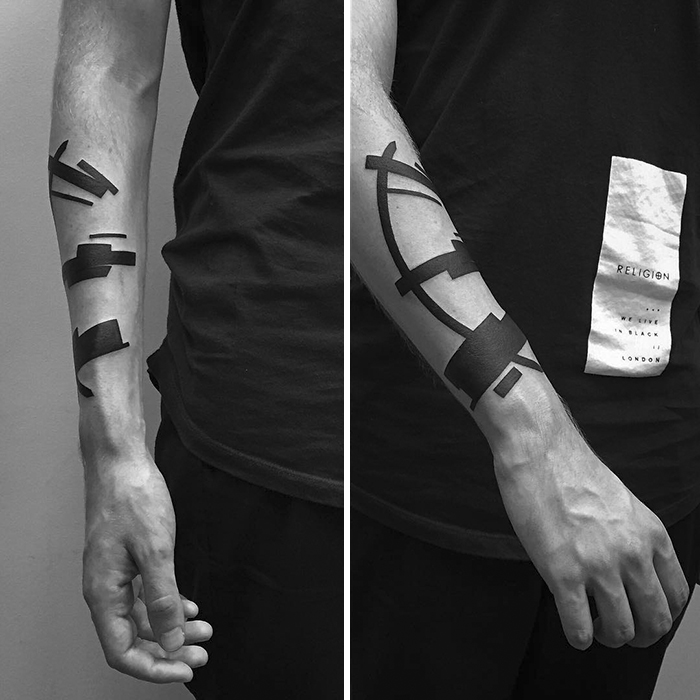 Minimalist digitally-designed tattoos on a person's forearm in a geometric style.