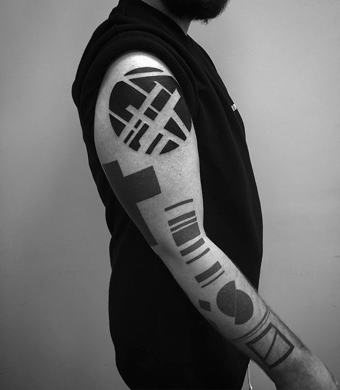 Minimalist digitally-designed tattoo with geometric patterns on a person’s arm.