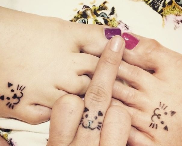 Cat tattoos on fingers and toes showcasing playful designs.