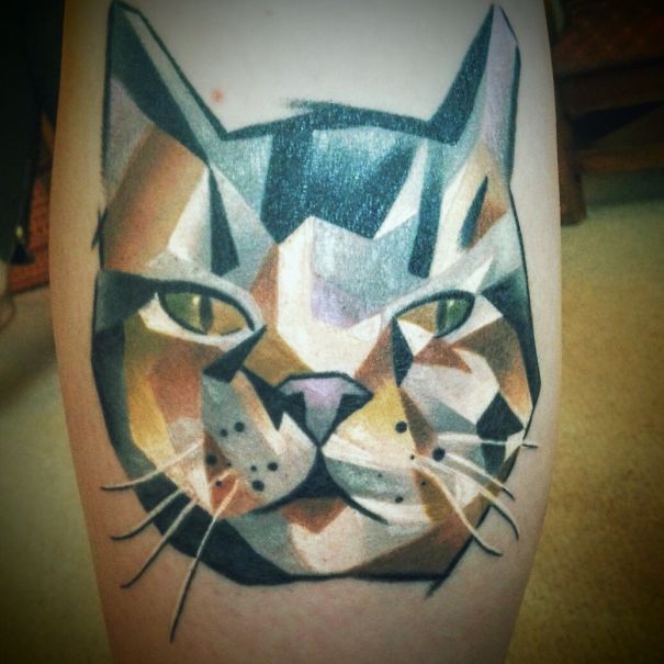 Geometric cat tattoo design on skin, showcasing unique artistry for cat tattoo enthusiasts.