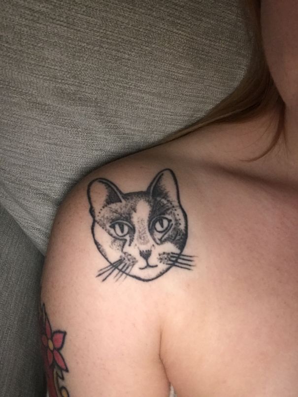 Cat tattoo on shoulder, showcasing detailed feline portrait for cat lovers.