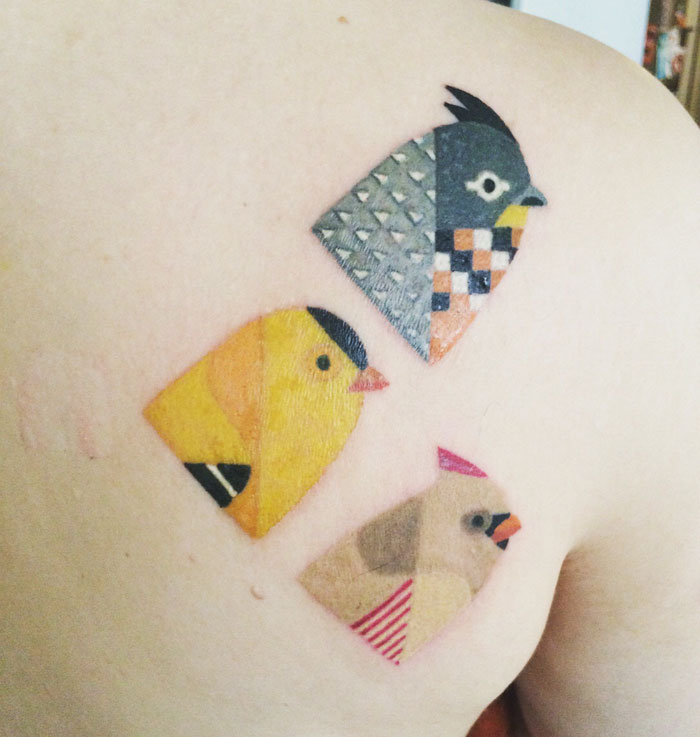 Unique small bird tattoos featuring geometric designs inked on skin.