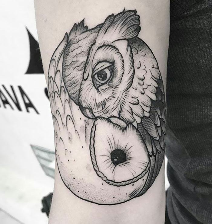 Detailed small bird tattoo with intricate shading on forearm.