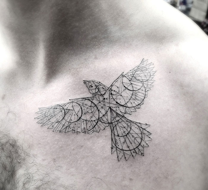 Geometric small bird tattoo design on a person's chest, showcasing intricate line work and dot details.