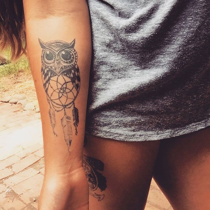 Owl tattoo with dreamcatcher on forearm, showcasing unique bird tattoo design inspiration.