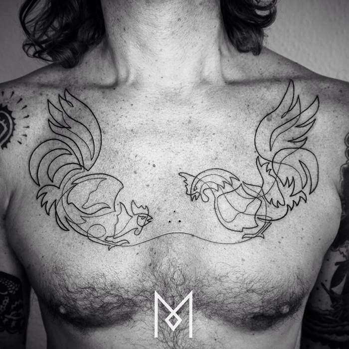 Minimalist small bird tattoo design on a man's chest featuring dynamic line work.