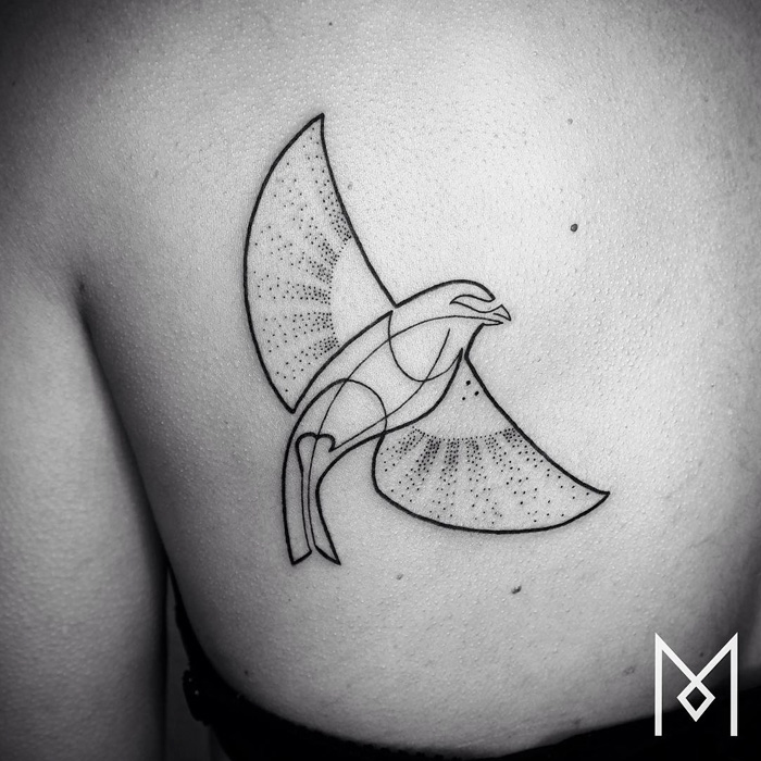Geometric small bird tattoo design on shoulder, featuring intricate dot patterns and bold lines.