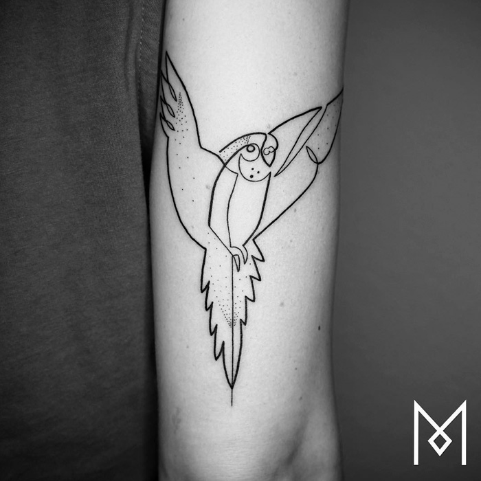 Line art small bird tattoo on forearm, showcasing unique minimalist design.