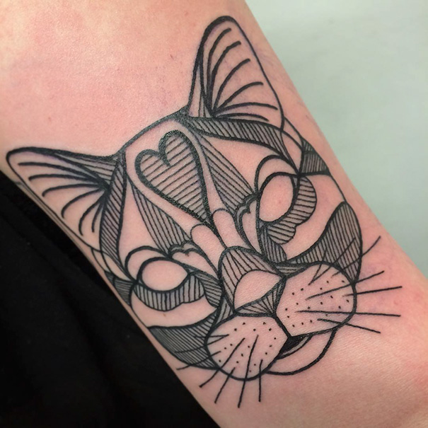 Geometric cat tattoo design on arm, showcasing creative expression for cat lovers.