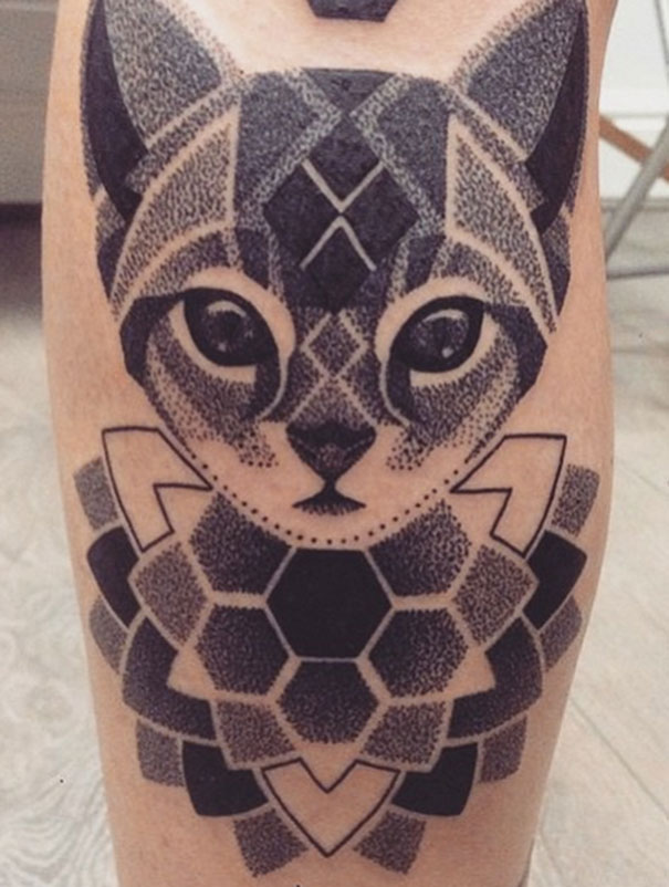Geometric cat tattoo design on skin, featuring intricate patterns and shapes for cat person expression.