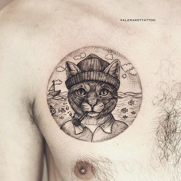 Cat tattoo of a sailor cat smoking a pipe, set against an ocean background with ships and fish.