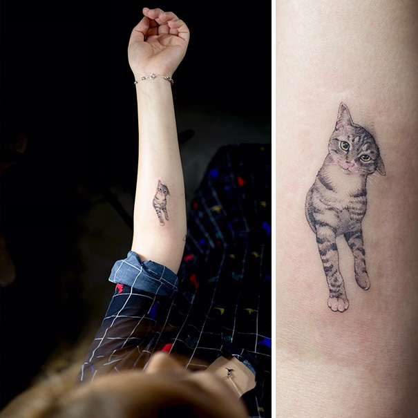 Cat tattoo on forearm featuring a realistic gray tabby design.