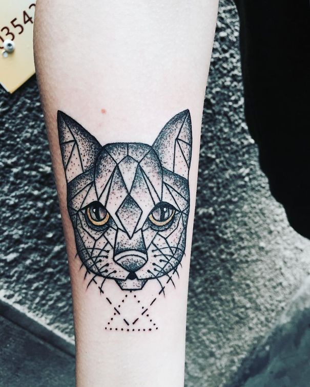 Geometric cat tattoo on forearm, showcasing intricate linework for cat person expression.