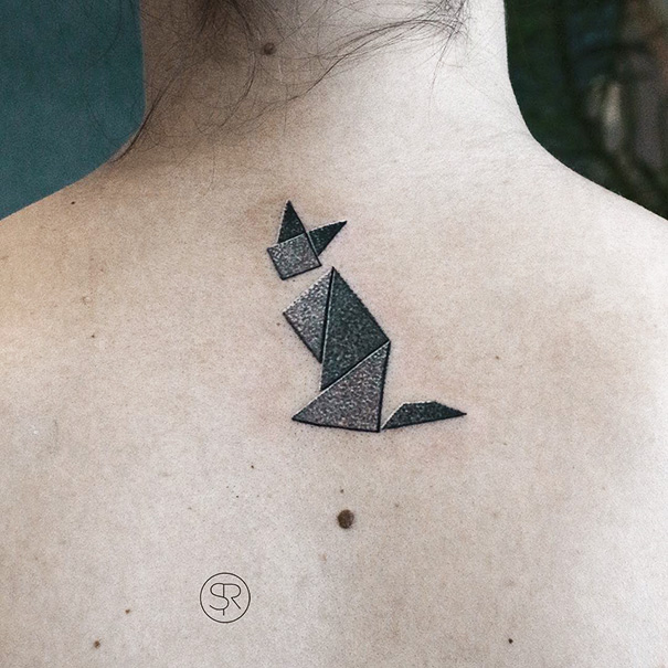 Geometric cat tattoo on skin, showcasing creative expression for cat lovers.
