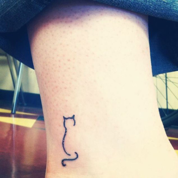 Minimal cat tattoo outline on ankle, perfect for cat persons.