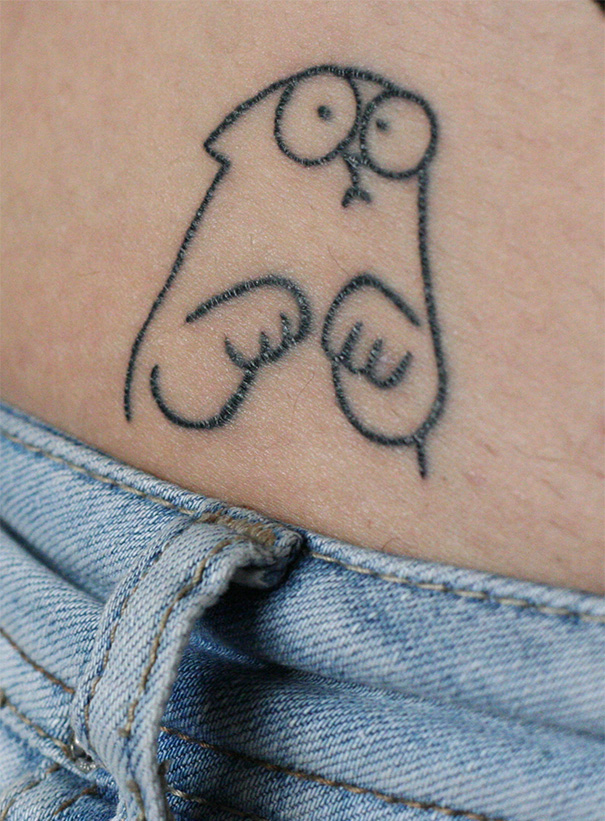 Simple cat tattoo design on the hip, showing a cute and minimalist cat drawing above denim jeans.