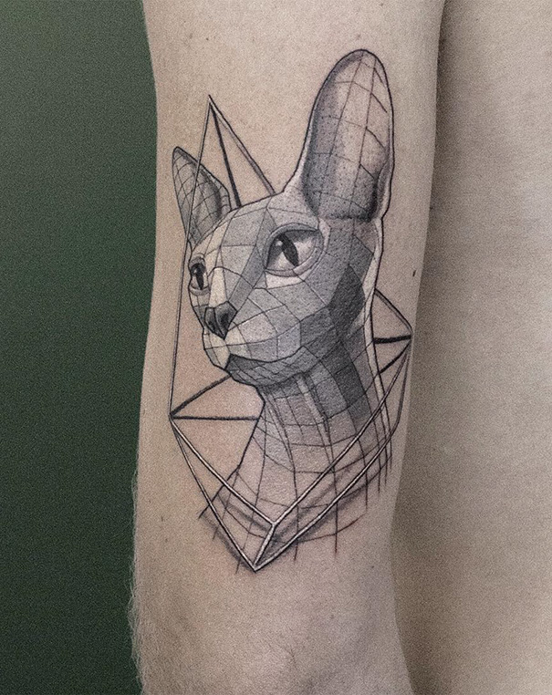 Geometric cat tattoo design on arm, showcasing creative ink art for cat lovers.