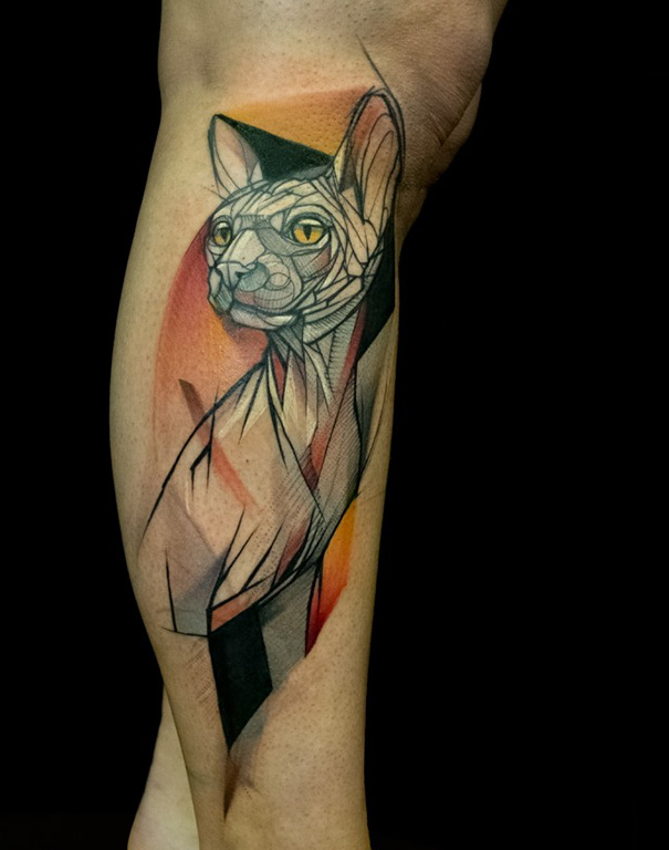 Geometric cat tattoo on leg, featuring bold lines and vibrant colors, perfect for cat person self-expression.