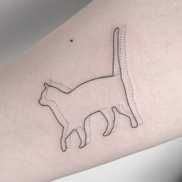Minimalistic line cat tattoo design on skin, showcasing unique cat person expression.