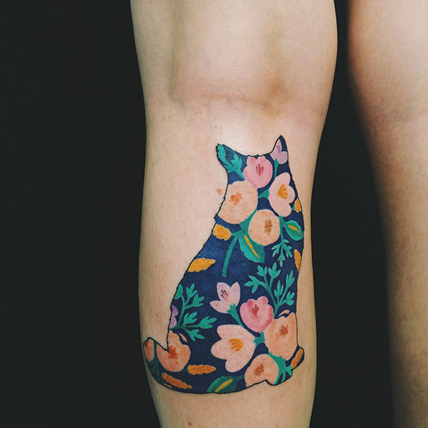 Floral cat tattoo design on arm, showcasing creativity for cat person self-expression.