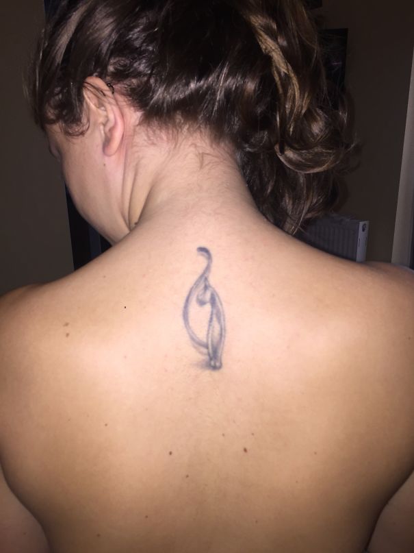 Minimalist cat tattoo on back, perfect for expressing yourself as a cat person.
