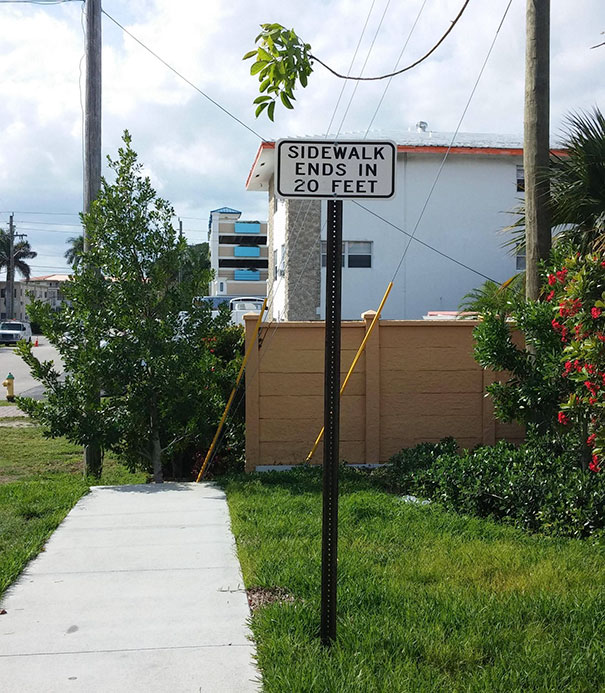 Picture of sidewalk and sign near it