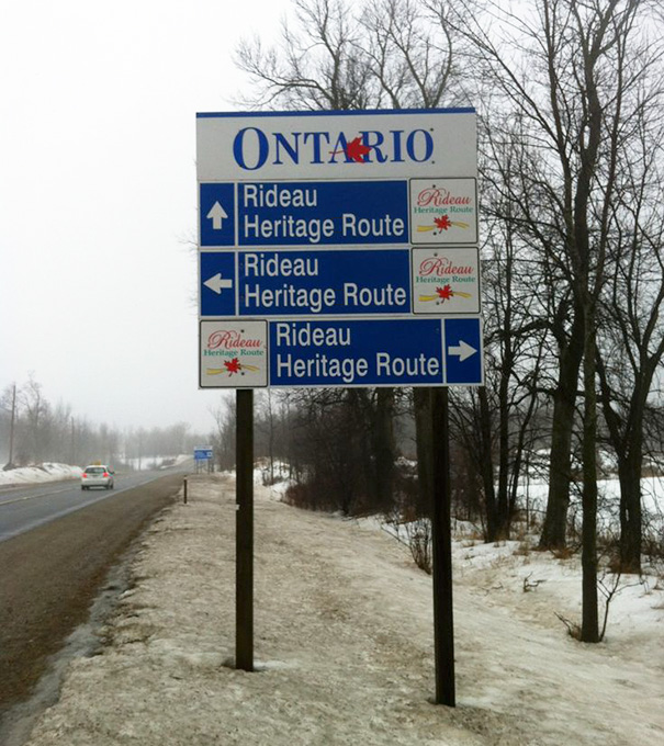 Picture of sign that says same place in different directions