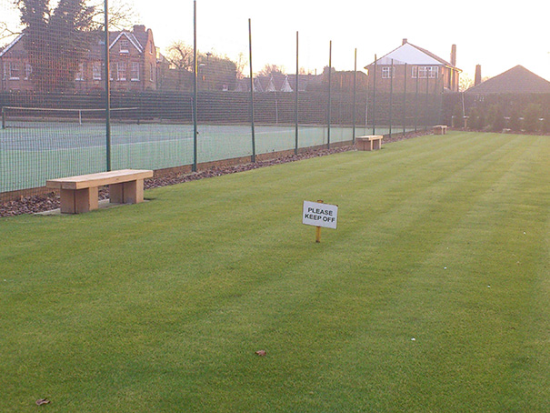 Field with fake grass and benches