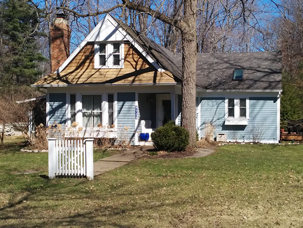 Picture of blue house with white small gates