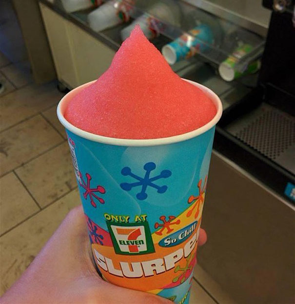 Perfectly filled red Slurpee cup at 7-Eleven, satisfying every perfectionist’s soul.