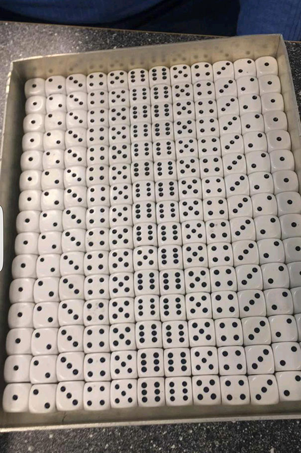 Tray of perfectly aligned dice, displaying numbers in a satisfying pattern for perfectionists.