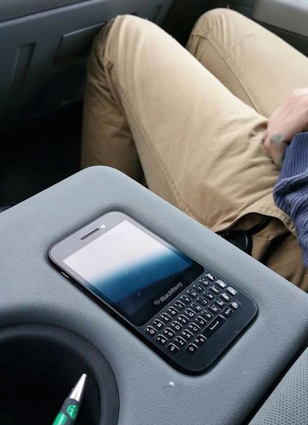 Smartphone perfectly aligned with car console, satisfying perfectionist desires.
