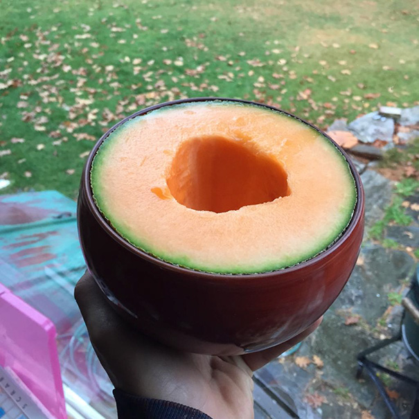 Perfectly spherical melon with a clean cut, satisfying perfectionists' souls.