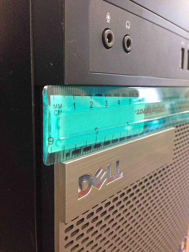 Ruler aligned perfectly with a Dell PC, satisfying a perfectionist's soul.