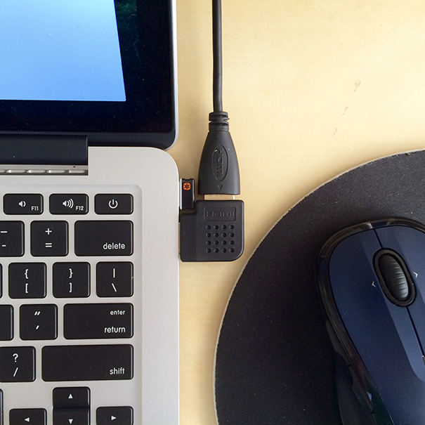 Perfectly aligned laptop cable and mouse on a desk, satisfying a perfectionist's soul with its neat order.