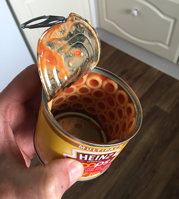 A perfectly opened Heinz spaghetti can, revealing neatly stacked pasta rings inside.