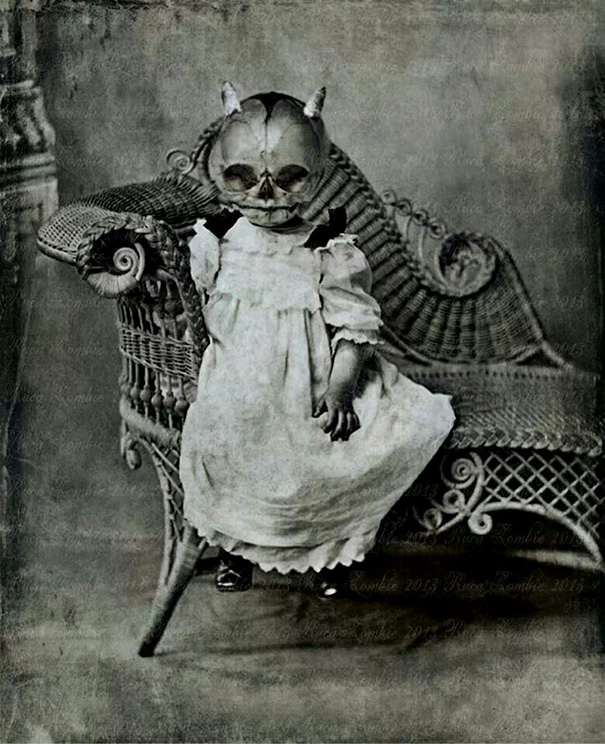 Child in a vintage Halloween costume wearing a skull mask and old-fashioned dress, sitting on a wicker chair.