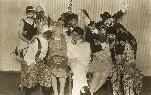Group of people wearing vintage Halloween costumes posing together in a black and white photo for Halloween costume inspiration