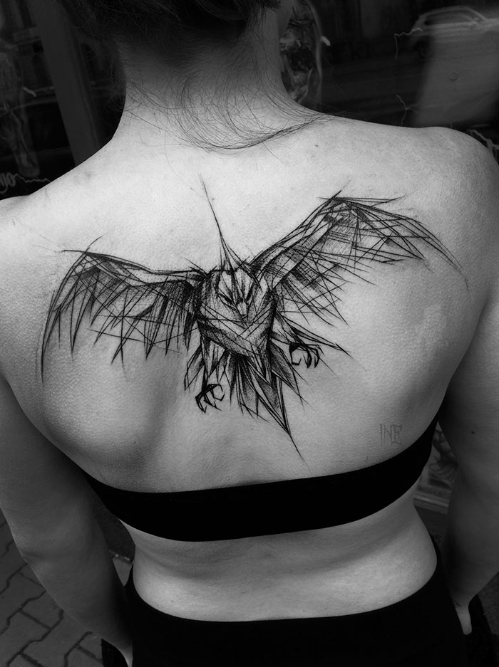 Back view of a person with a sketch tattoo of an abstract owl design by a Polish tattoo artist, showcasing beauty in imperfection.