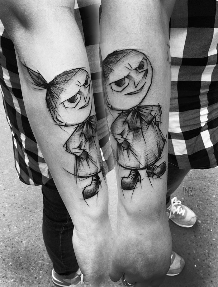 Sketch-style tattoos by Polish artist, depicting a cartoon character on two forearms, highlighting beauty in imperfection.